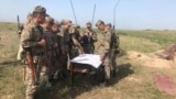 Kazakhstan -- Military cadets being instructed outdoors. A training field.