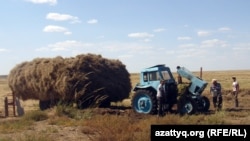 Крестьяне ремонтируют трактор в селе Курылыс. Актюбинская область, сентябрь 2012 года.