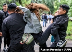 Полицейские задерживают сторонника оппозиции 10 июня 2019 года в Алматы, на следующий день после президентских выборов в Казахстане