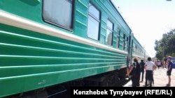 Kazakhstan – Passengers stand next to board a train at Ayaguz / Ayagoz railway station. East Kazakhstan region, 03Aug2014