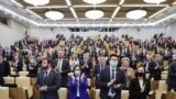 Russia -- Attendees stand during a plenary meeting of the Russian State Duma